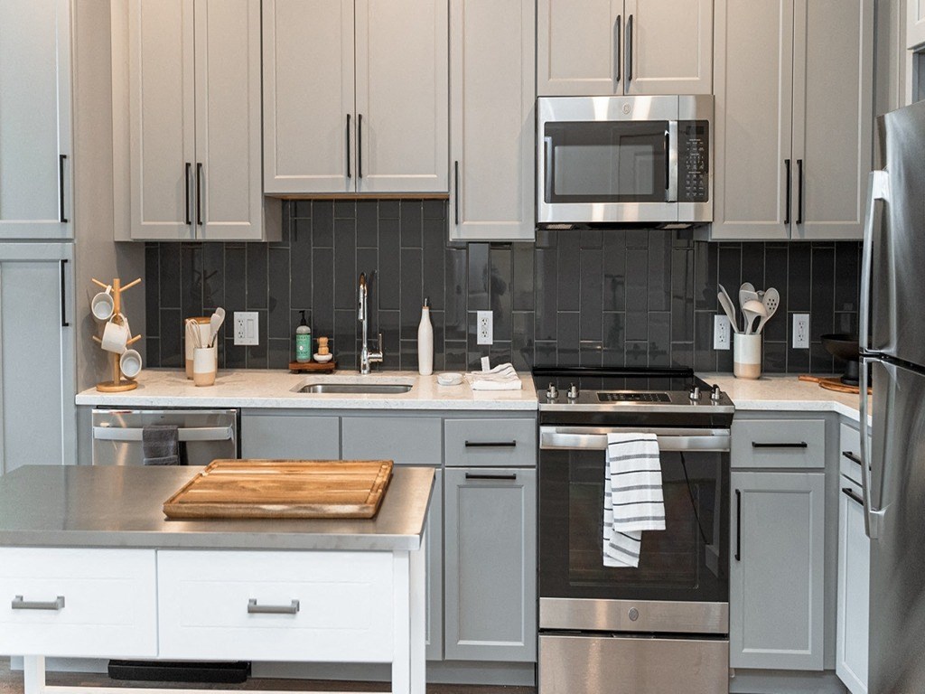 a kitchen with stainless steel appliances and white cabinets
